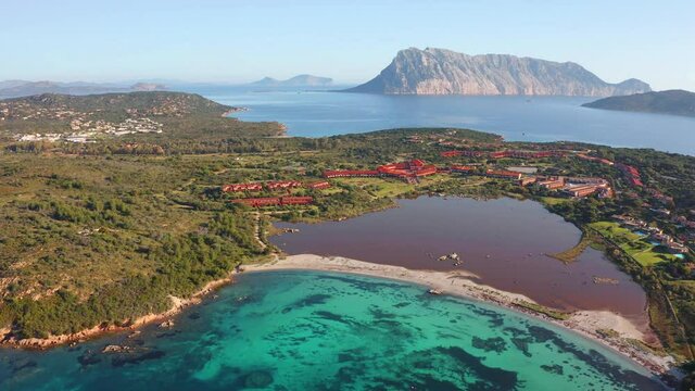 4K aerial - a bird's eye view&nbsp;video (Ultra High Definition). Captivating summer scene of Salina Bamba beach with Tavolara mountain on background. Captivating morning view of Sardinia island, Italy.