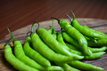 fresh green chilies on chopping board for spicy vegetable 