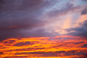 Fototapeta na wymiar Dramatic sunset vivid orange colored clouds 