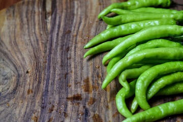 fresh green chilies on chopping board for spicy vegetable 