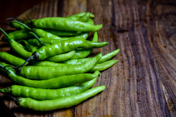 fresh green chilies on chopping board for spicy vegetable 