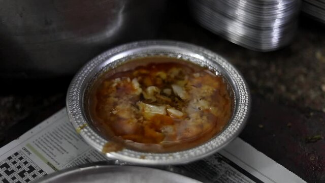 Garnishing nihari at famous Javed Nihar in Zakir, Nagar Delhi