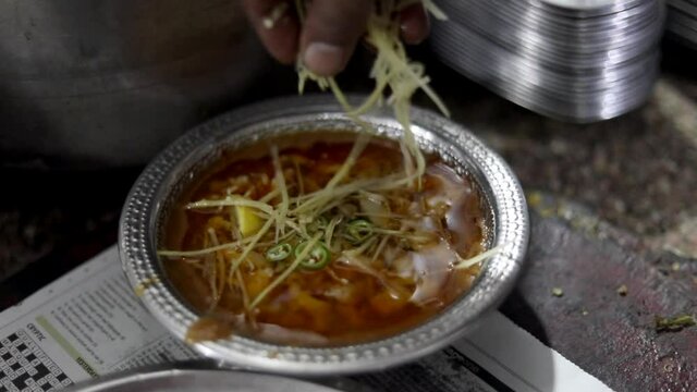Garnishing nihari at famous Javed Nihar in Zakir, Nagar Delhi
