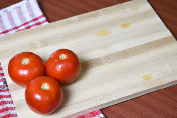 fresh red tomato on wooden chopping board  for vegetables