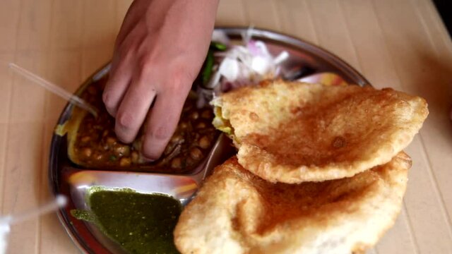 Indian bread Chole Bhature at Darshan with onion in New Delhi, India
