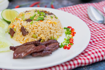 Thai food : Close up Fried rice with salted beef on white plate Served with Cucumber, and Lime, healthy food,