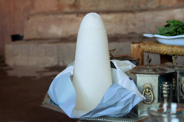Image of a white sugar cone or loaf as an ingredient to make mint tea at berber families in the Atlas mountains,Morocco.