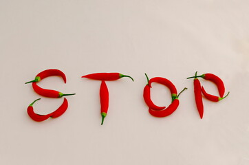 Sign or symbol Stop, made from the fruit of fresh chilli red pepper with a green stalk, Sofia, Bulgaria. Suitable for inclusive education. 