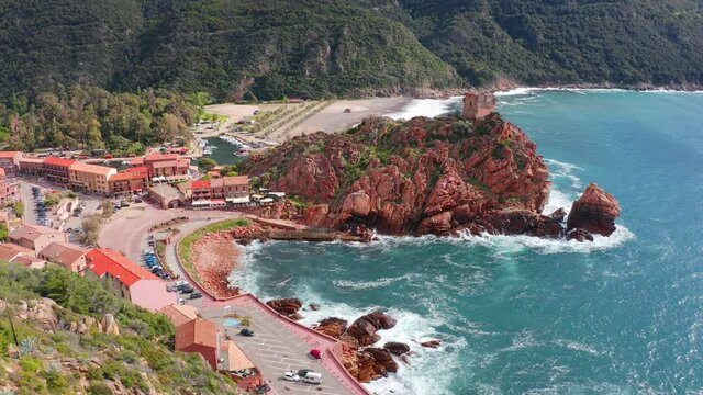 4k drone flight moving to the side footage (Ultra High Definition).  Incredible summer cityscape of Porto town with Genoise de Porto Ota tower. Aerial morning view of Corsica island, France, Europe.
