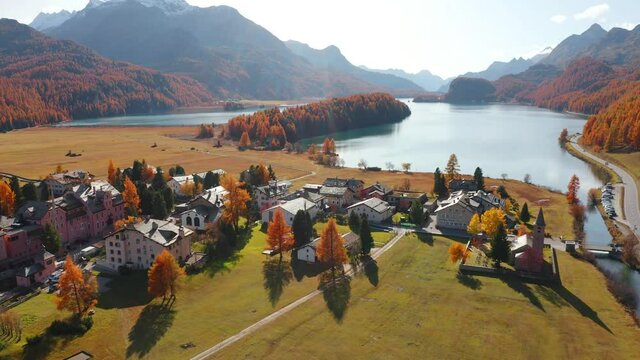 4k drone forward video (Ultra High Definition) of of San Lurench church in Sils im Engadin village. Captivating morning scene of Swiss Alps. Beautiful landscape of Sils lake, Switzerland, Europe.