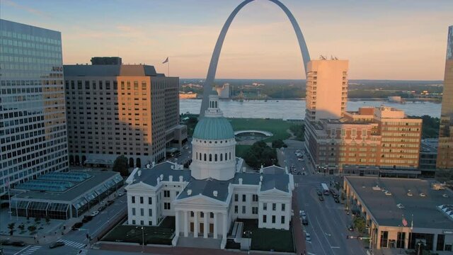 Aerial: St Louis Old Courthouse & The Gateway Arch at sunset, Missouri, USA