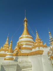 view of Golden Pagoda with blue sky background, Wat Chong Kham, Mae Hong Son, northern of Thailand.