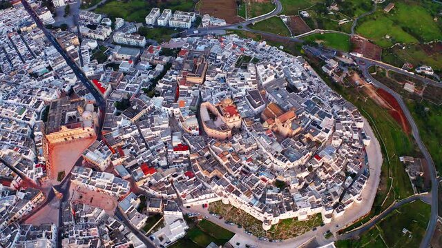 4k drone flight above footage (Ultra High Definition). Splendid morning cityscape of Ostuni town. Fantastic sunrise in Apulia, Italy, Europe. Traveling concept background.