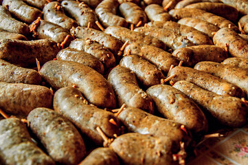Many small grilled sausage on table.