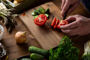 Sliced tomatoes on wooden board, cooking vegan food