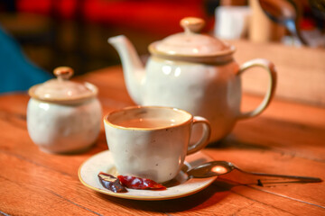 White tea set served on a rustic wooden table in a restaurant. Tea time. Ceramic tea set. Eating out concept.