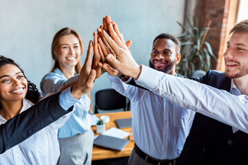 Colleagues Giving High-Five Celebrating Business Success Standing In Office