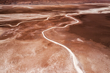 Aerial view of salt lake and dry white river beds making patterns and lines in a dry desert landscape