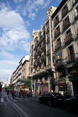 Calle Mayor, Old Madrid city centre, busy street with people and traffic