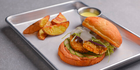 Gourmet tasty steak burger with fries. Juicy delicious craft burger with spices and baked potatoes.