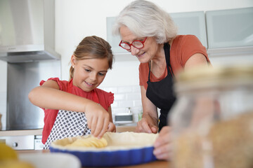 Grandmother with grandkid making apple pie