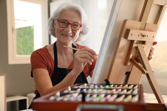 Senior Woman Painting On Canvas