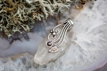 Fashionable ornamental crystal quartz silver decoration pendant on grey agate background