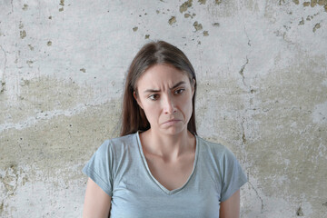 Portrait of disgusted woman, girl showing disgust for bad smell or taste