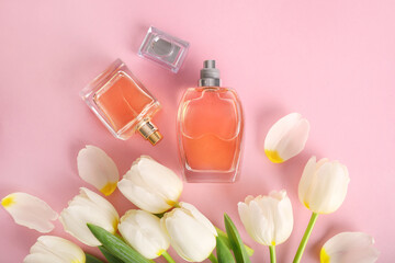 Beautiful perfume bottle and tender white tulips