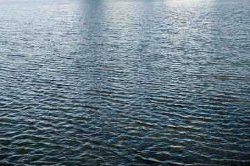 blue water surface, small waves on the river
