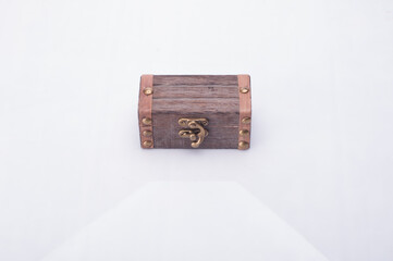 A miniature treasure chest isolated over white