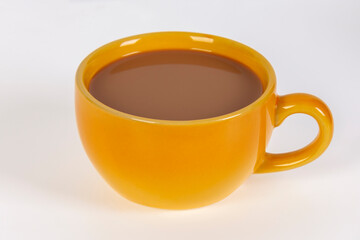 Coffee with milk in a yellow cup on a white background.