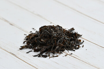 Dry tea leaves lie on the table. Russian Ivan tea.