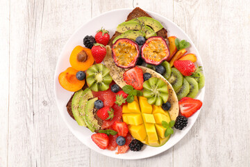mixed colorful fruit with mango, berry fruit, apricot, avocado
