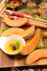 fresh melon slices with oli, ham- mediterranean buffet food