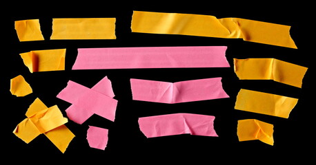 Colorful adhesive paper tape strips, isolated on black background, top view