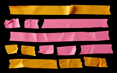 Colorful adhesive paper tape strips, isolated on black background, top view