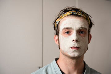 Man with a beauty face mask at home