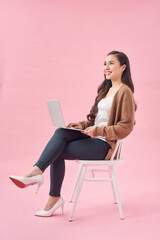 Girl is surfing through the Internet and looking for some interesting information. She is working on her laptop.