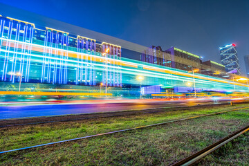 Obraz premium tram tracks and light trails in city at night