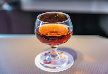 Glass of cognac, business class flight service image