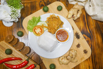 crispy fried chicken with fresh vegetable on wooden board background