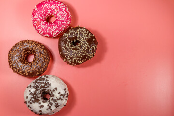 Tasty donuts on pink background. Top view, copy space