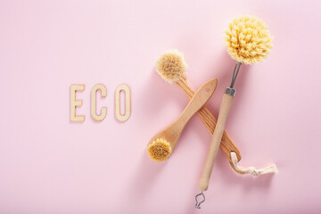 zero waste eco friendly cleaning concept. wooden brushes on pink background