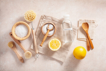 Fototapeta na wymiar zero waste eco friendly cleaning concept. wooden brushes, lemon, baking soda, vinegar