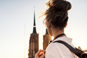 Young blonde tourist is exploring beautiful european city streets