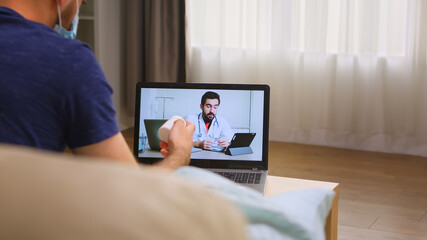 Man having an online consultation with his doctor during coronavirus quarantine.