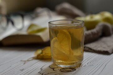 a stack of books on the table and a cup of tea with lemon