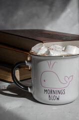 coffee with marshmallows and books on the table
