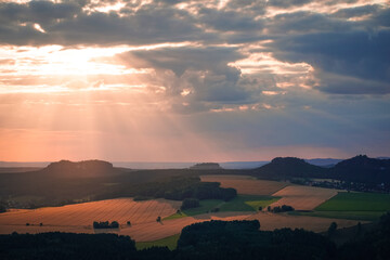 Sunrays shining through the clouds during sunset in Saxon Switzerland, Germany